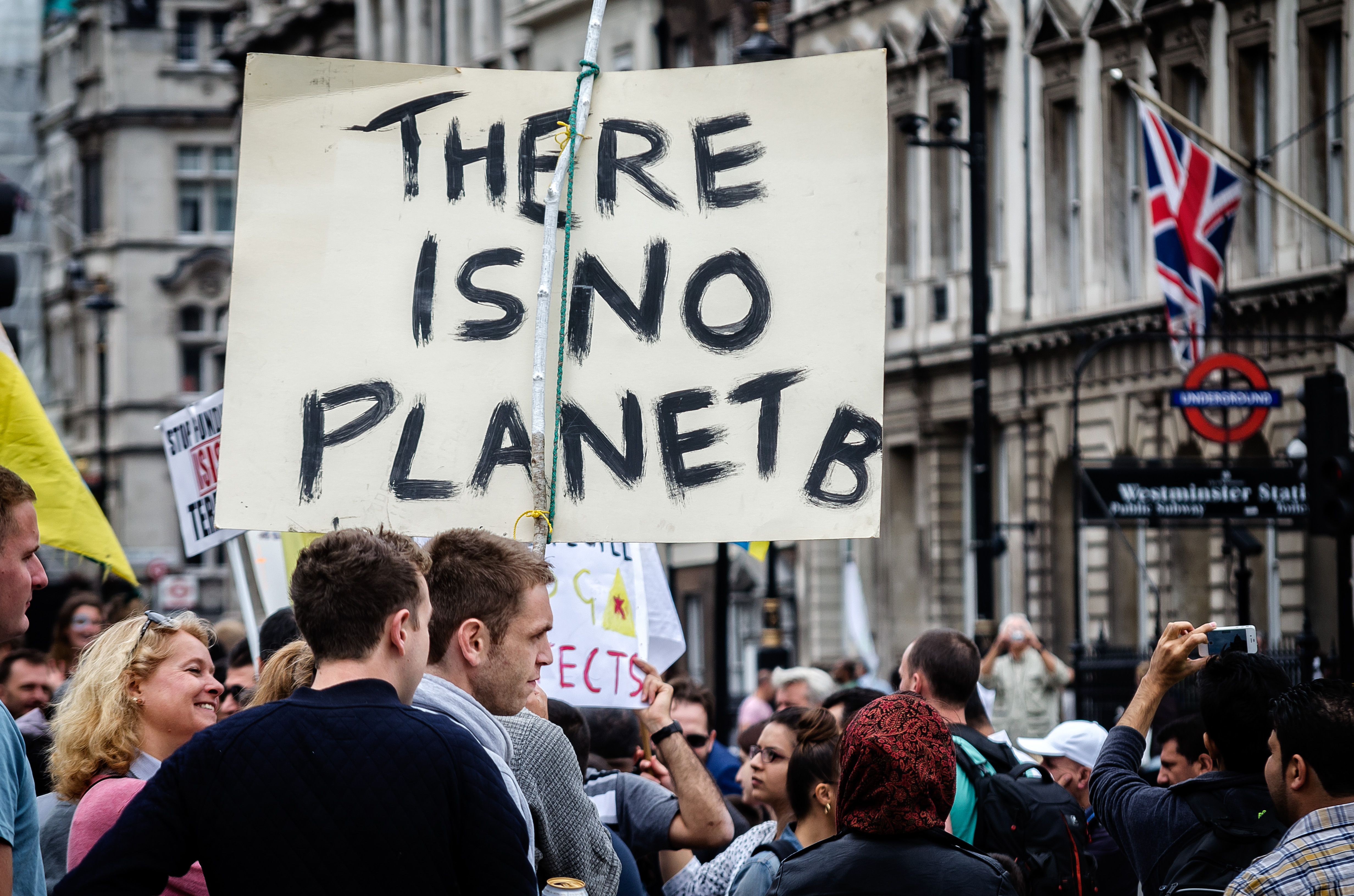 Protester holding a 'There is no planet B' sign at a climate march